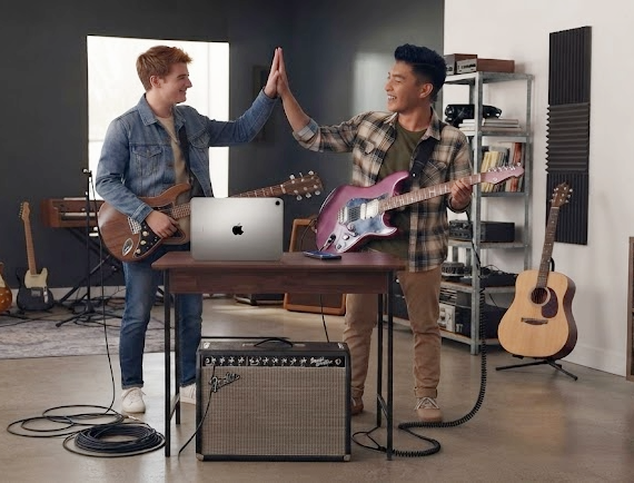 Two guitarists celebrating progress in a home studio